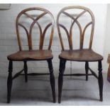 A pair of 19thC oak and elm framed, hoop and lace back Windsor chairs, the solid seats raised on