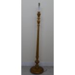 A modern carved and turned, candle style giltwood standard lamp, on a circular base  50"h