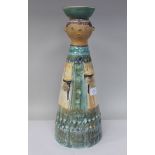 A Roos Kiss art pottery standing figure, holding two stemmed cups with a bowl on the head  16.5"h