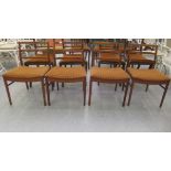 A set of four McIntosh teak framed bar back dining chairs, the fabric seats raised on tapered