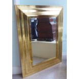 A modern mirror, the bevelled plate set in a moulded gilt frame  33" x 42"