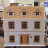 A modern dolls house with hinged doors, on a plinth  32"h  32"w