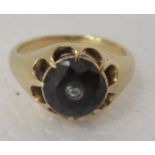 An 18ct gold gypsy ring, set with a garnet