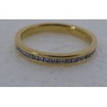 A gold coloured metal, rubover set diamond half eternity ring  stamped 750