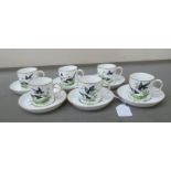 A set of six Royal Crown Derby china Cuthbert Gresley coffee cans and saucers, painted with magpies