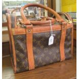 A Louis Vuitton make-up bag with stitched brown hide handles