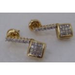 A pair of gold coloured metal pave set diamond pendant earrings