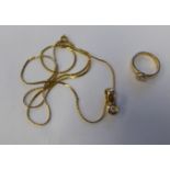 A 15ct gold band ring, rubover set with a cubic zirconia; and a matching pendant, on a fine box link