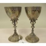 A pair of late 19thC silver Gothic inspired goblets with uniformly engraved decoration, each ovoid