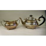 A silver teapot of oval, bulbous form with dragooned and shell cast decoration, a swept spout,