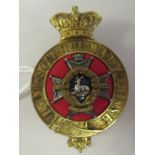 A military officer's badge for Notts & Derby Regiment with a red cloth and blue enamel centre (