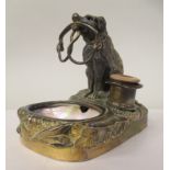 A novelty brass and mother-of-pearl desk-top tidy, featuring a seated dog, holding a riding crop