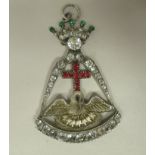 A paste set white metal, hinged pendant, featuring a crown, over a cross and swan with spreading