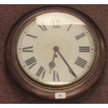 An early 20thC turned and stained beech framed wall timepiece; the movement faced by a painted steel