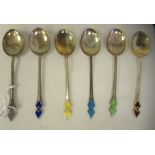 A set of six Art Deco silver coffee spoons, each with a variously coloured enamelled arrow feather