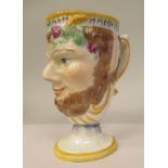 A 19thC Prattware novelty satyr's head frog jug with a loop handle, on a pedestal foot  4.75"h