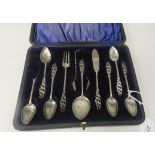 Edwardian silver tea set accoutrements with decoratively scrolled stem terminals  comprising a set