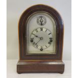 An Edwardian satinwood string inlaid, rosewood cased, round arch mantel clock, on button feet; the