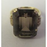 A 9ct gold claw set smokey quartz dress ring