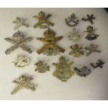 Approx. sixteen military cap badges and other insignia, some copies, relating to Machine Gun