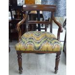 A modern William IV design beech framed open arm chair, raised on turned forelegs