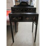 A child's early 20thC black painted and gilded desk, embellished with floral designs and domestic