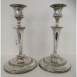 A pair of loaded silver candlesticks  London marks rubbed  8.75"h