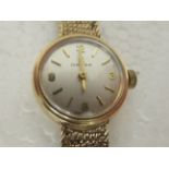 A lady's Omega 9ct gold cased bracelet wristwatch, faced by an Arabic and baton dial