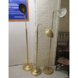 A pair of modern lacquered brass floorstanding reading light, the shell pattern shade on a