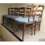 A set of eight French country made, stained beech framed ladderback dining chairs with woven rush