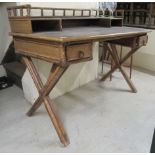 A 20thC Anglo-Indian style bamboo and woven split cane, kneehole writing table with a low,