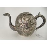 An early 20thC Asian white metal, bulbous teapot, having an S-shaped spout, loop handle and lid,