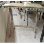 A modern grey painted and grained centre table, the top having a fretworked apron, elevated on twin,