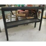 A modern matt black finished, narrow, two tier galleried side table, raised on square supports  32"h