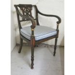 A Regency inspired stained and overpainted elbow chair with a level crest, pierced splat and open,