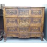 An early 20thC Continental oak breakfront, three drawer dressing chest, raised on stubby cabriole