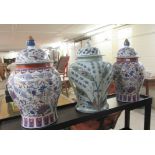 A pair of modern Chinese porcelain temple jars of waisted baluster form with covers, traditionally