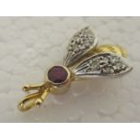 A bi-coloured metal pendant, fashioned as a bee, set with coloured stones  stamped 14k