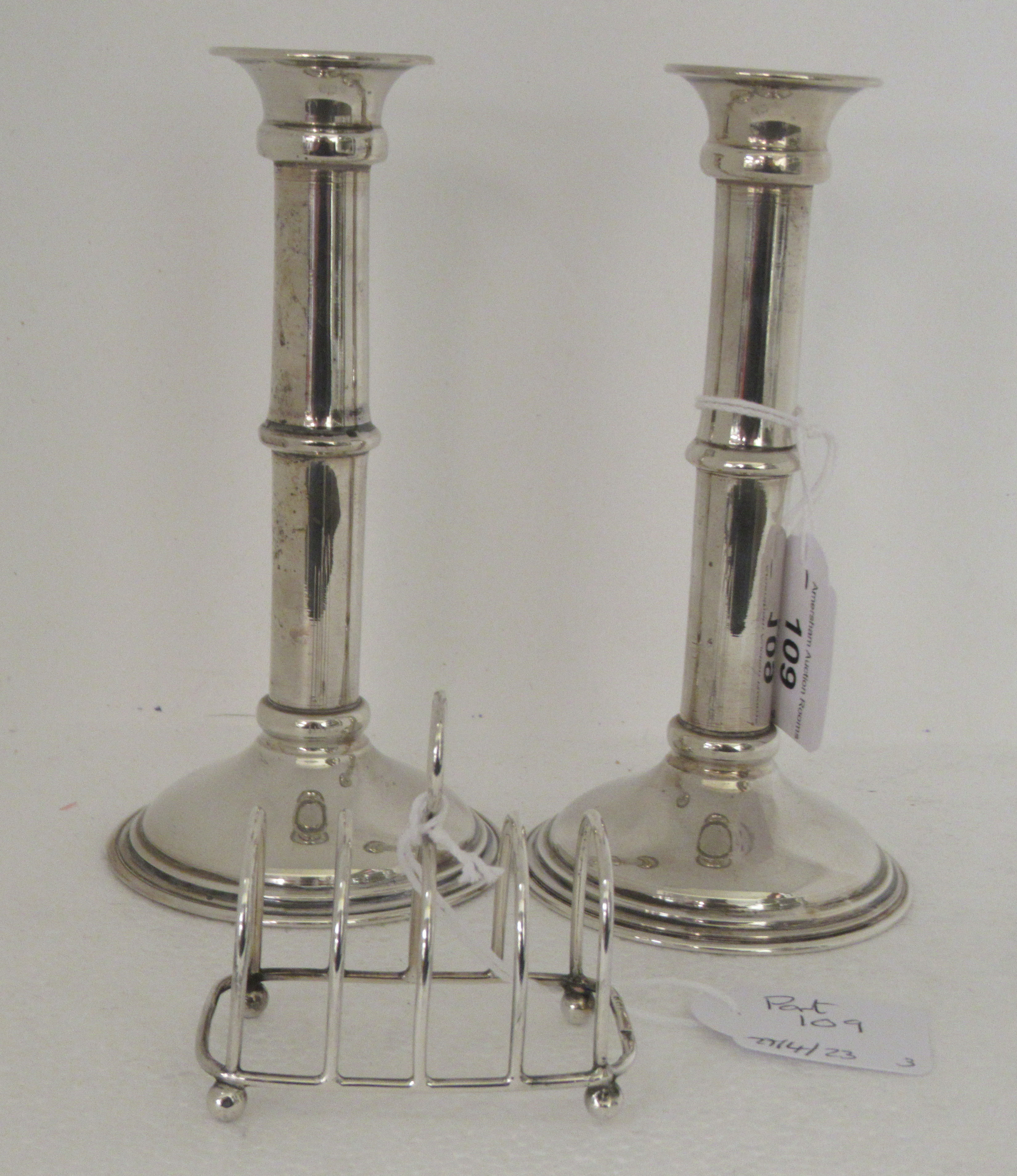 A pair of silver coloured metal candlesticks with knopped, tubular stems  stamped 800  7"h; and a