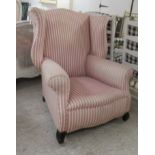 A modern, small Georgian style wingback armchair, upholstered in pink and white striped fabric