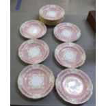 A set of twelve Continental pink and cream glazed and gilded ribbon plates  8"dia
