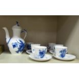 A Royal Copenhagen porcelain coffee pot and six cups, decorated in blue and white with floral