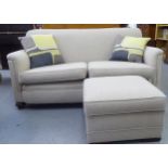 A modern two seater box settee with a level back and enclosed arms, upholstered in biscuit