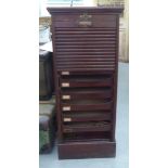 An early 20thC mahogany (damaged) tambour front, nine drawer filing cabinet  45"h  19"w