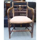 A Regency mahogany framed elbow chair with a low back and open arms, the upholstered seat pad raised