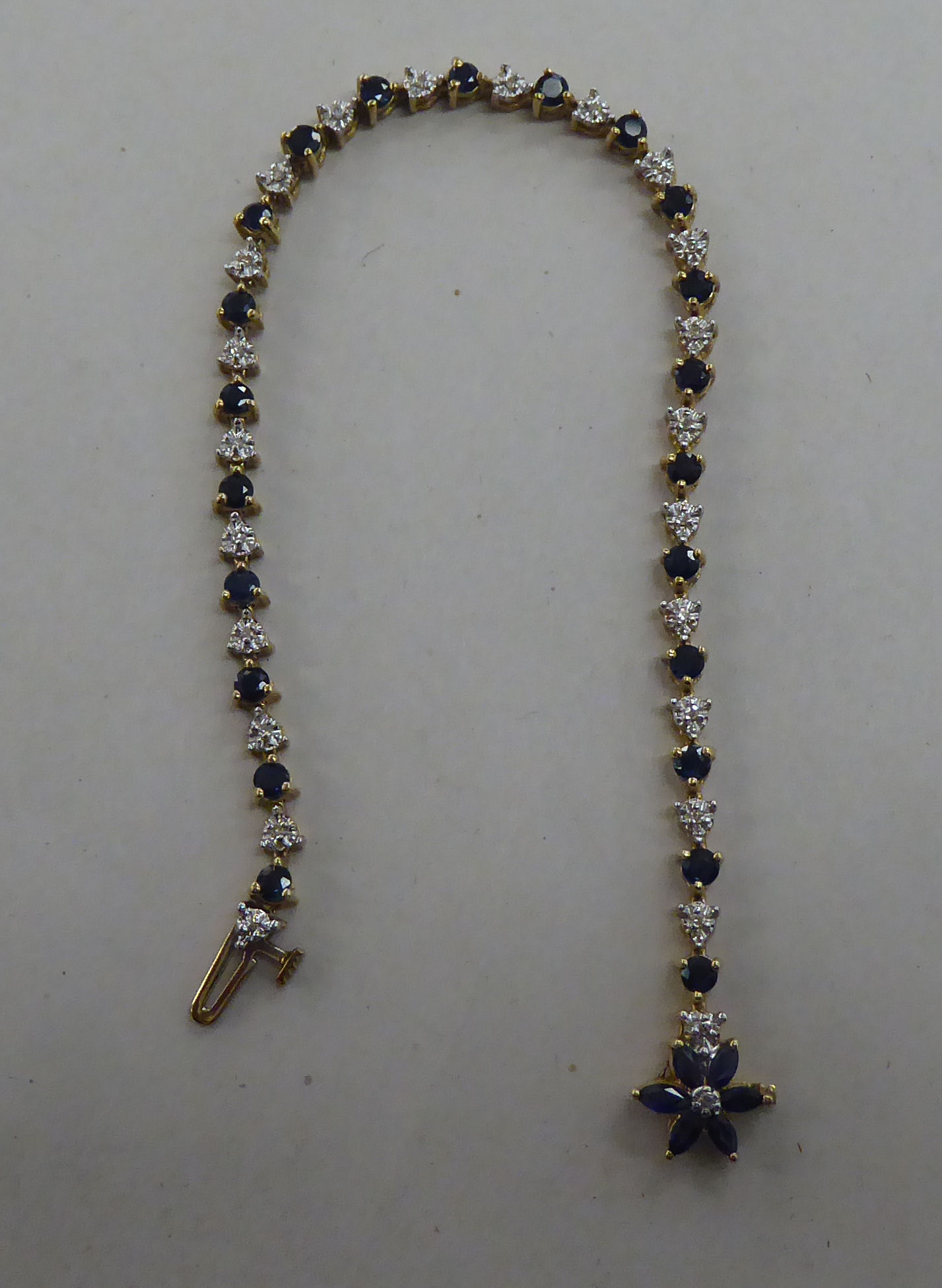 A 10k gold bracelet, set with sapphires and diamonds