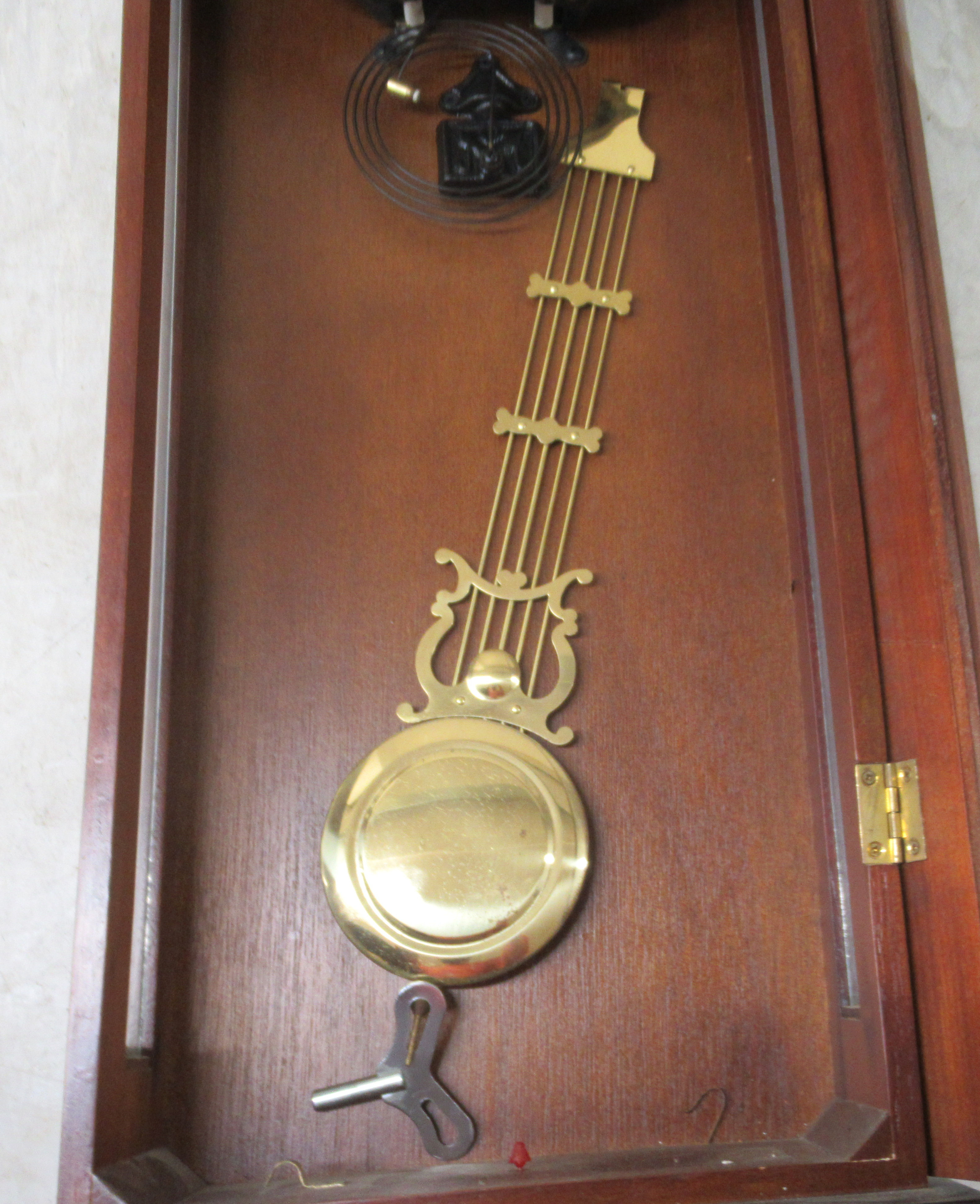 A modern mahogany cased and glazed wall clock; the 31 day movement faced by a Roman dial  43"h - Image 2 of 4