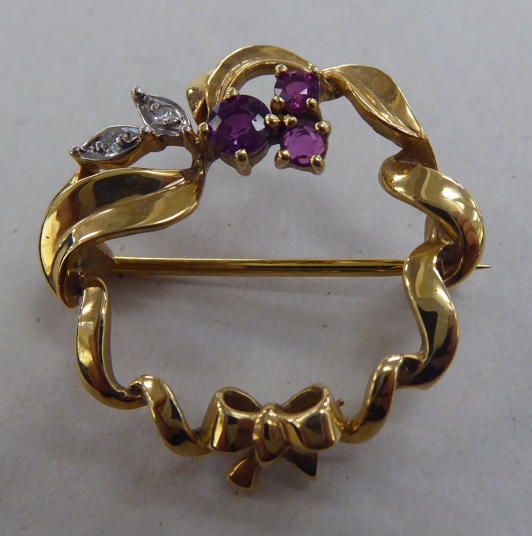 A 9ct gold brooch, set with rubies and diamonds