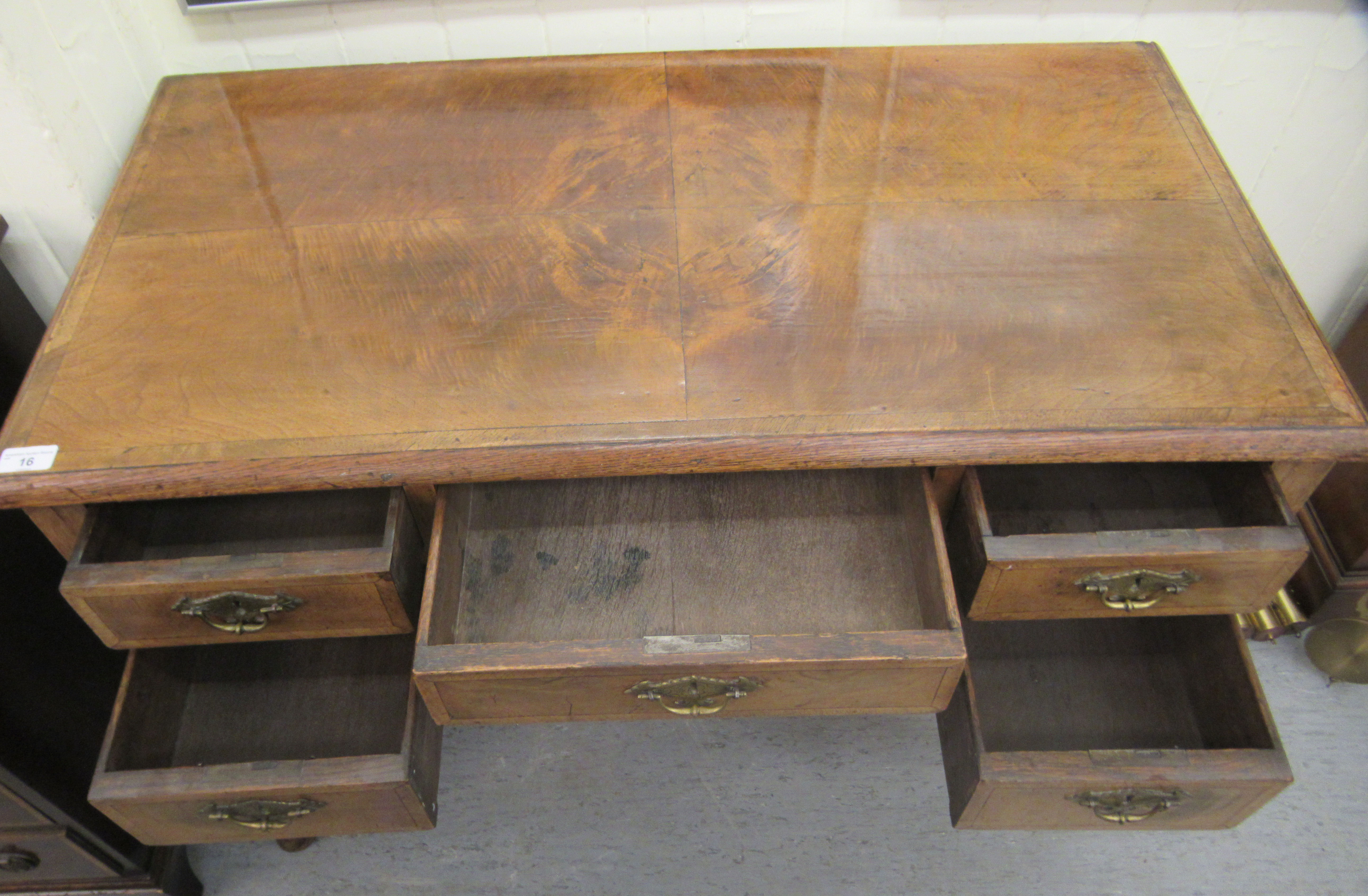 A late 19th/early 20thC crossbanded mahogany and walnut, five drawer kneehole desk, raised on - Image 3 of 5