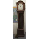 A modern yewwood longcase clock; the movement faced by a Roman dial with (three weights and